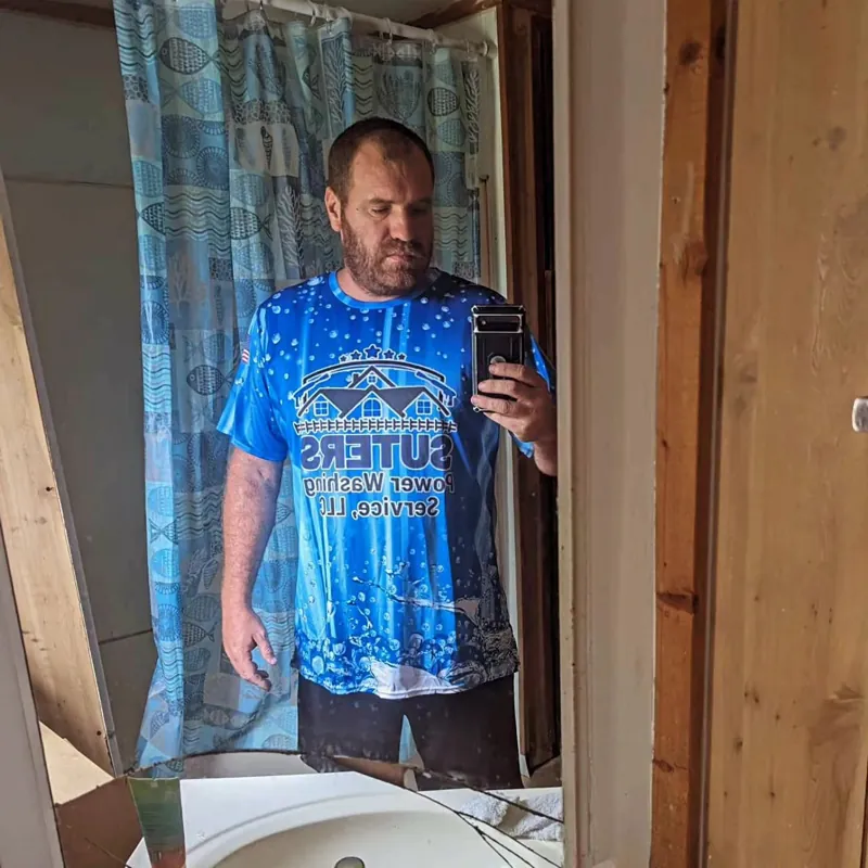 Suters Powerwashing customer wearing a blue custom shirt