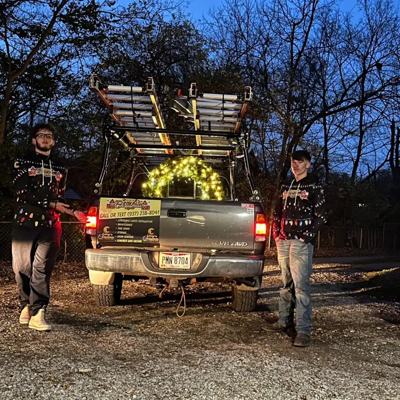 Conor crew wearing custom shirts beside their work truck