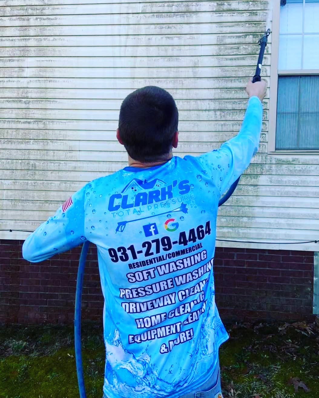 Clark’s Total Pressure customer wearing a branded shirt while washing a house