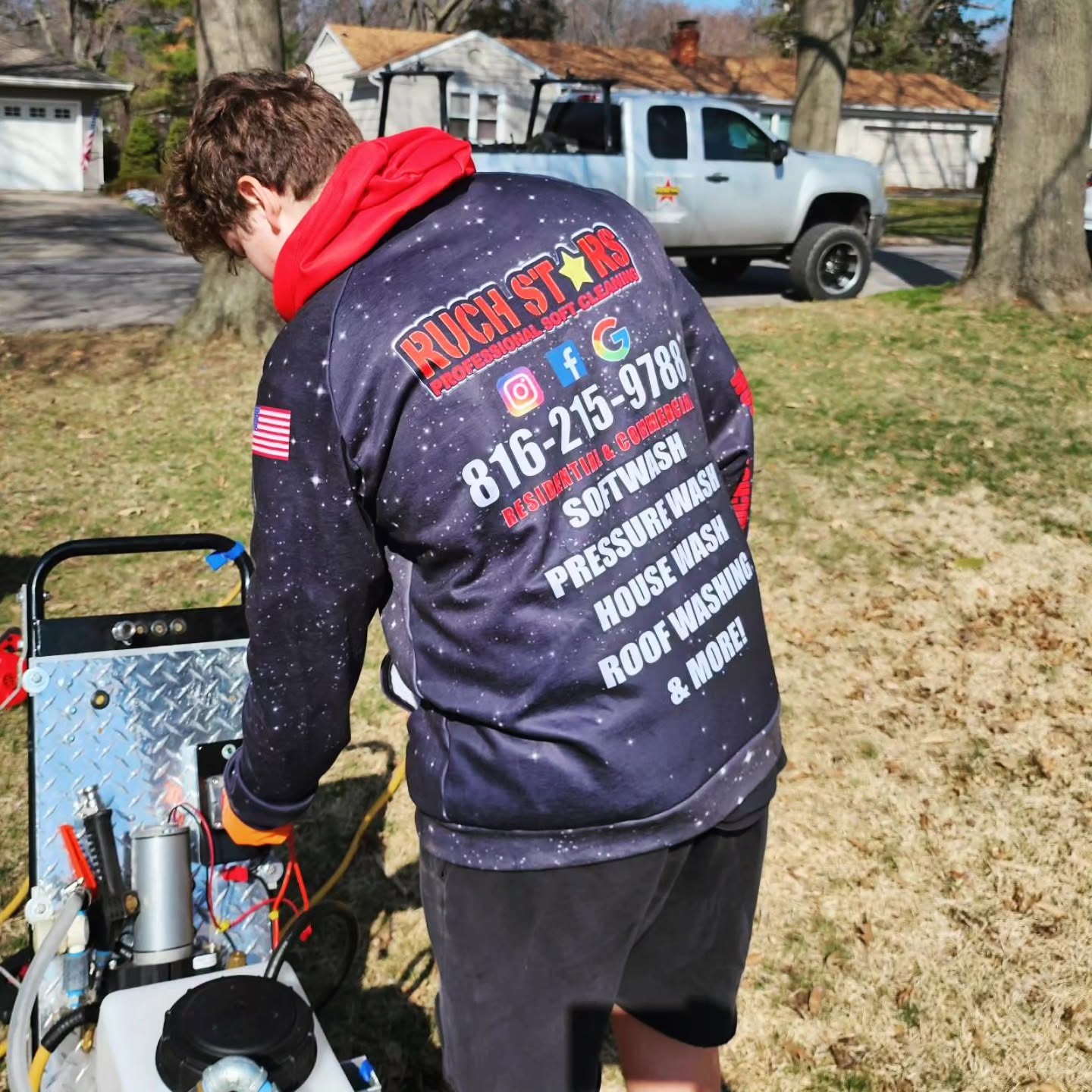 Ruchstars customer wearing a branded hoodie beside cleaning equipment